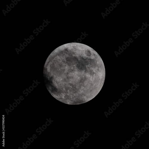Isolated close up of the full moon with light cloud cover