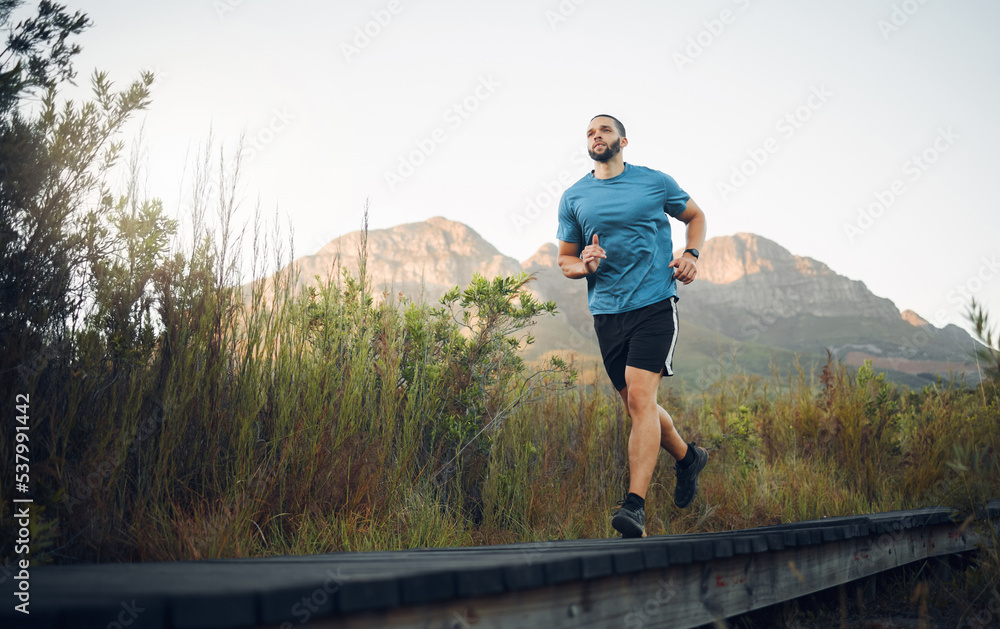 Runner, fitness and man in nature running for outdoor workout, healthy energy and wellness goal with sky mock up background. Sports person with exercise training motivation jogging near the mountains
