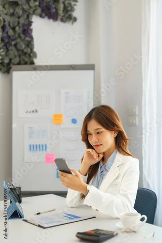 Successful business concept, Businesswoman using smartphone to relaxation after hard working © Pichsakul