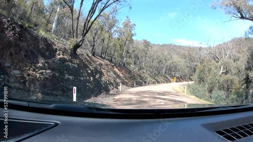 GoPro tracking shot of a car traveling over an Australian highway while traversing a forest and rocky terrain.