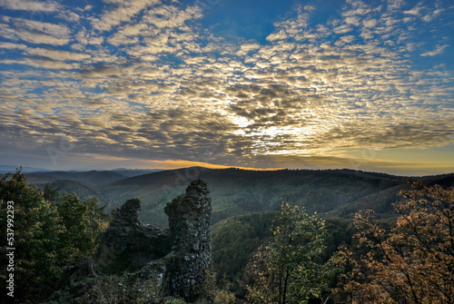 Autumn landscape at sunset with the wall of the castle ruin. Beautiful blue sky, cluster of clouds.. Vrsatec, Slovakia.