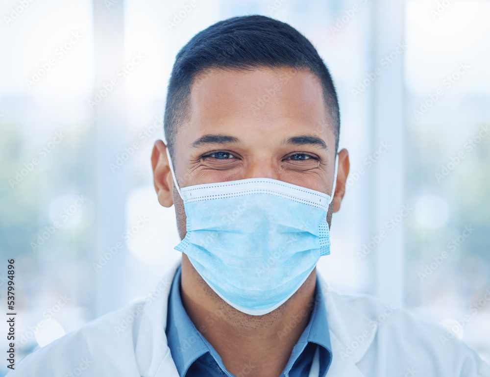 Covid, face mask and portrait of a happy doctor in a hospital working, smiling and helping with healthcare expertise. Smile, compliance and medical worker with coronavirus safety protection in India Covid, face mask and portrait of a happy doctor in a hospital working, smiling and helping with healthcare expertise. Smile, compliance and medical worker with coronavirus safety protection in India