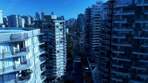 downtown Vancouver laneway homes modern architectural marvel glass high-rises built in 2021-2022 in between older buildings made in 1980s-1990s on a sunny summer fall day aerial drone flyby closeup photo