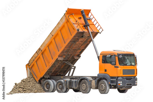 Unloading soil from a dump truck. The work of construction equipment in the production of earthworks