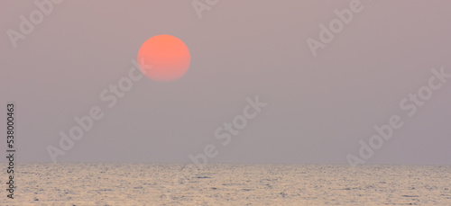 sunrise with orange warm sun at the sea on vacation in egypt panorama