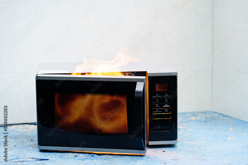 microwave oven on fire. the concept of fire in the kitchen and