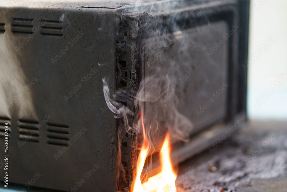microwave oven on fire. the concept of fire in the kitchen and