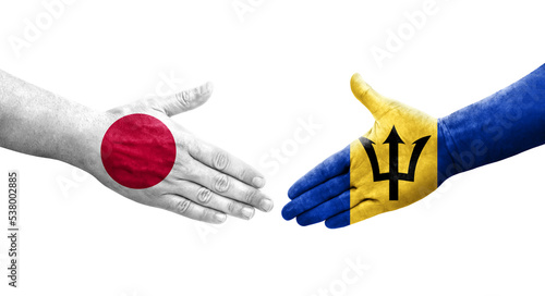 Handshake between Barbados and Japan flags painted on hands  isolated transparent image.