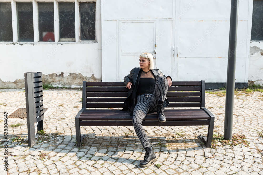 Young beautiful strong independent rebel blonde woman Punk music and style fan posing. Confident Punk-Rock youth culture concept. Young beautiful strong independent rebel blonde woman Punk music and style fan posing. Confident Punk-Rock youth culture concept.