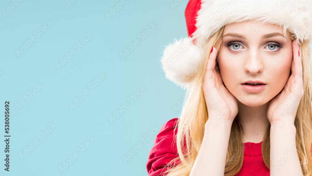 Portrait of young and pretty girl in Santa hat. New year and Christmas concept. Portrait of young and pretty girl in Santa hat. New year and Christmas concept.