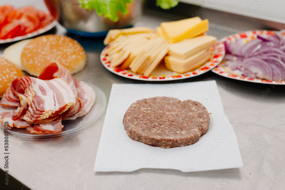 The process of making a burger. Ingredients for making a burger. Everything you need to make a burger is laid out on the table. The process of making a burger. Ingredients for making a burger. Everything you need to make a burger is laid out on the table.
