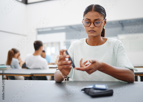 Photography Diabetes, finger prick and black woman with blood sugar test to check glucose level sitting at desk in class