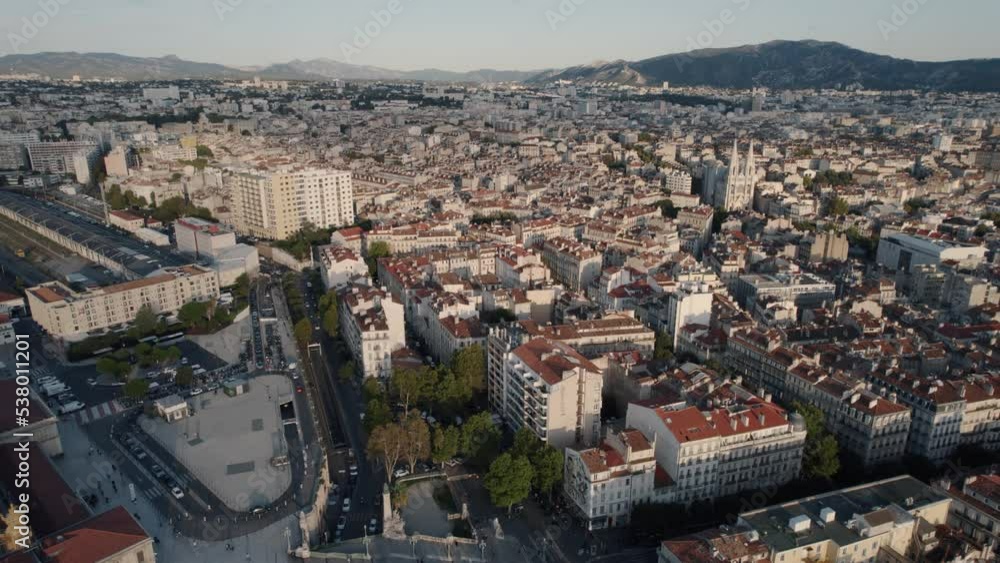 Slow aerial panning shot of the beautiful city of marseilles above the wonderful buildings and view of the mountains in the background Slow aerial panning shot of the beautiful city of marseilles above the wonderful buildings and view of the mountains in the background