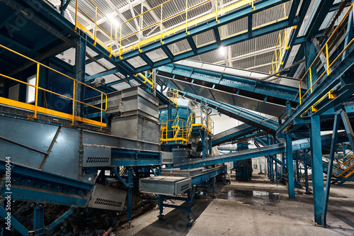 Large production line with conveyors carrying trash at plant