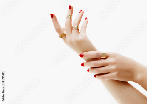 Woman Jewelery concept. Womans hands close up wearing rings and bracelet modern accessories elegant life style. Beige background 