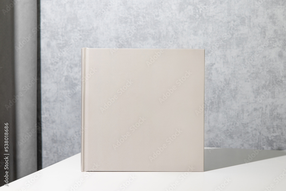 Grey book mock up, great design for any purposes. Technology concept. Business concept in grey room interior Grey book mock up, great design for any purposes. Technology concept. Business concept in grey room interior