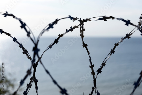 Barbed wire fence at sea.