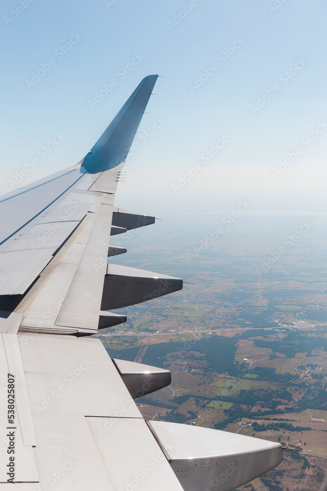 wing of an airplane in flight seen from the window