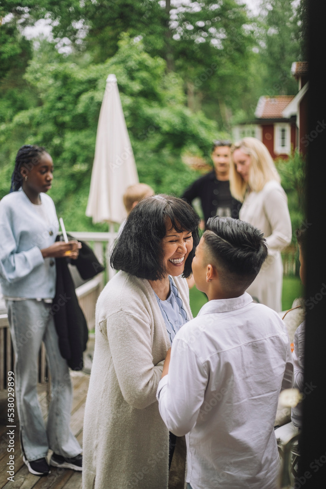 Happy grandmother looking at grandchild at party Happy grandmother looking at grandchild at party