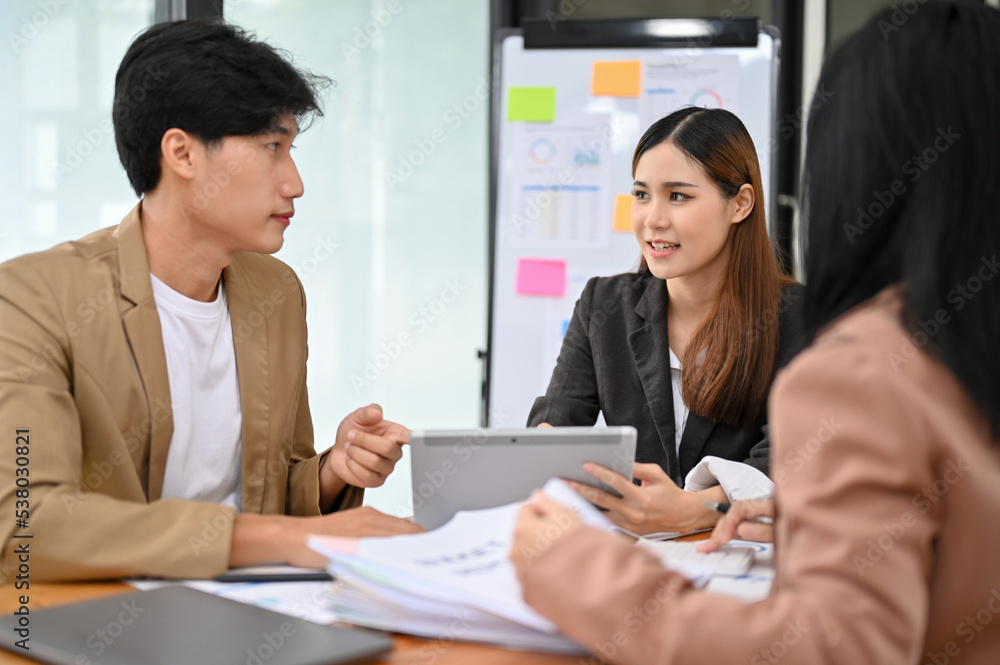 Professional Asian businesswoman discussing with her colleague in the financial meeting. Professional Asian businesswoman discussing with her colleague in the financial meeting.
