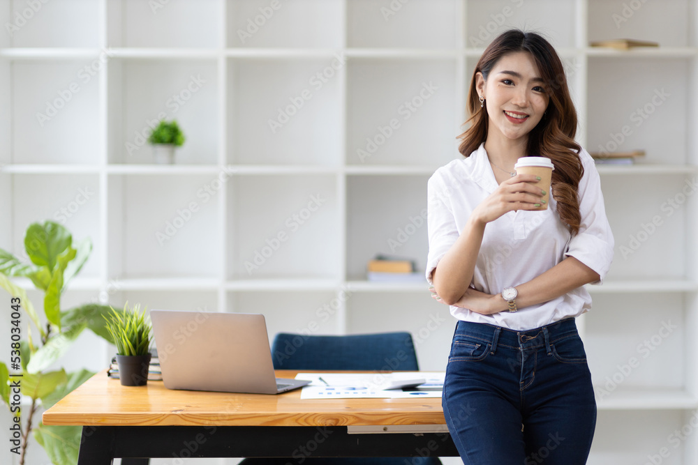 Portrait of a charming young Asian business woman in the office looking and smiling. Portrait of a charming young Asian business woman in the office looking and smiling.