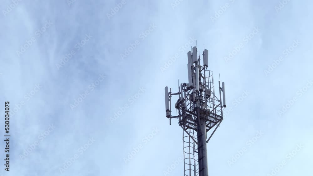 Cellular GSM Tower with 3g 5g Transmitter Cell Tower Mobile Communication Mobile Operator Tower and Blue Sky and White Clouds Time Lapse. Cellular GSM Tower with 3g 5g Transmitter Cell Tower Mobile Communication Mobile Operator Tower and Blue Sky and White Clouds Time Lapse.