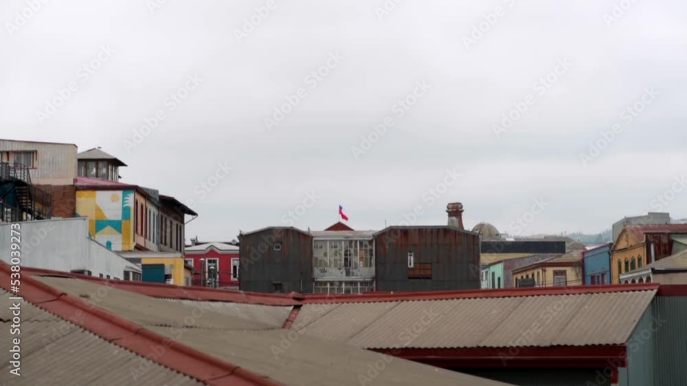 Handheld of colorful houses of Cerro alegre and Chilean flag in the background, cloudy day, Valparaíso, Chile Handheld of colorful houses of Cerro alegre and Chilean flag in the background, cloudy day, Valparaíso, Chile
