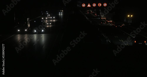 timelapse of a german highway at night with cars speeding past accelerating overtaking one another filmed from a bridge at 8pm in autumn 4k high quality film camera photo