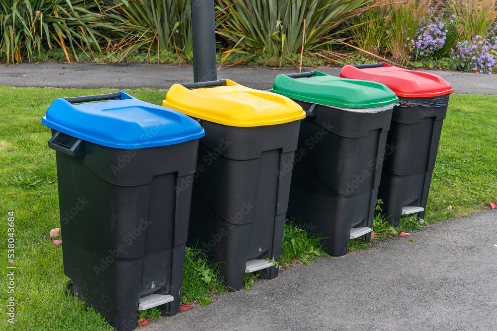 Colour coded black recycle bins for rubbish waste and litter of plastic