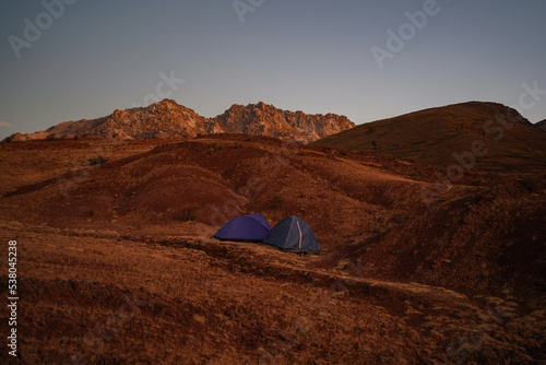 Wild camping at dusk with two tents in a landscape around Maragua crater, Sucre, Bolivia.