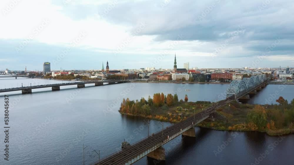 Aerial View of Riga City the Capital of Latvia. Amazing View on the River Daugava, Old Town, National Library, Bridges Over the River and the Main Tv Tower. View From Above During Autumn Cloudy Day 4K Aerial View of Riga City the Capital of Latvia. Amazing View on the River Daugava, Old Town, National Library, Bridges Over the River and the Main Tv Tower. View From Above During Autumn Cloudy Day 4K