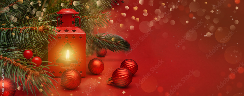 Fototapeta premium Spruce, fir branches, lantern, red baubles on red background. Christmas greeting card. Christmas lights. Frame border. Christmas composition. Space for text. Banner.