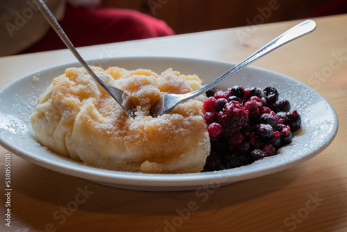 A Slovenian dessert: struklji , a traditional Slovene dish, composed of dough and a filling of sweet cottage cheese, served with berries photo