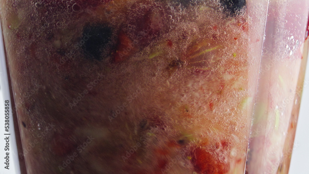 Fototapeta premium Closeup rotation blending fruits berries inside blender in super slow motion.