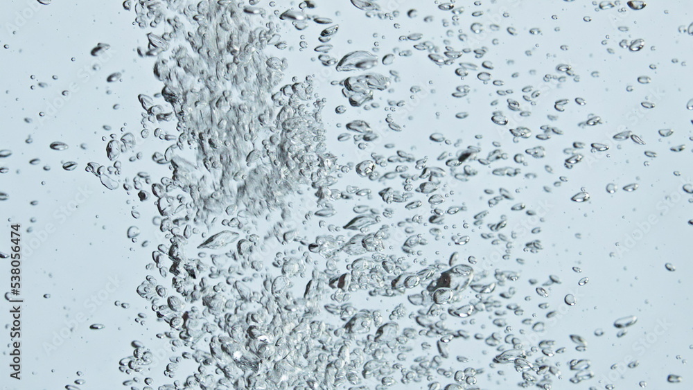 Air bubbles rising water surface closeup. Refreshing sparkling fluid flowing