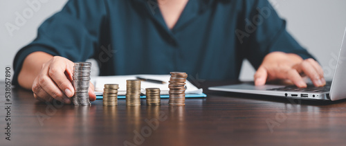 Saving investment banking finance concept. Stack of coins with piggy bank on the table. Growth of loan and investment business idea. Asset Management, Funds, Liabilities, Deposits, Income, Successful.