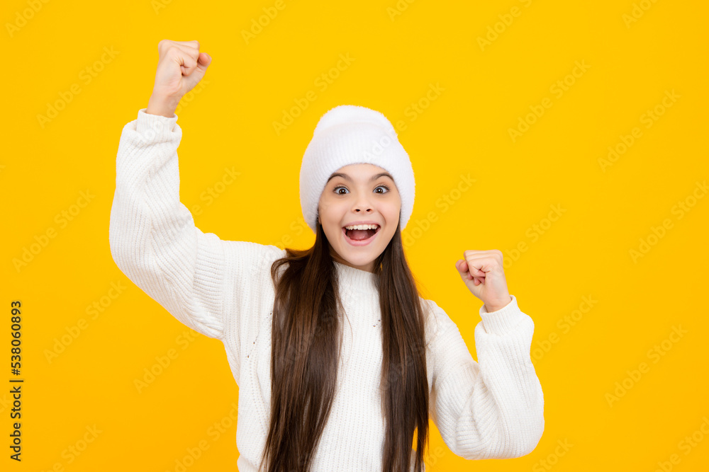 Excited face. Portrait of teenage girl child doing winner gesture. Kid rejoicing, yes victory champion gesture, fist pump. Amazed expression, cheerful and glad. Excited face. Portrait of teenage girl child doing winner gesture. Kid rejoicing, yes victory champion gesture, fist pump. Amazed expression, cheerful and glad.