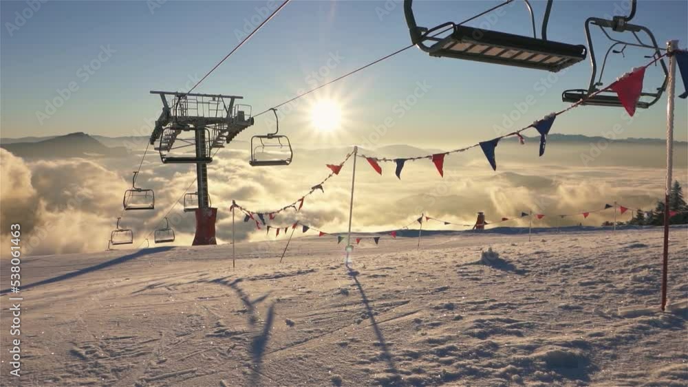 Magic sunny winter morning in mountains ski resort with empty chairlift starting in new day