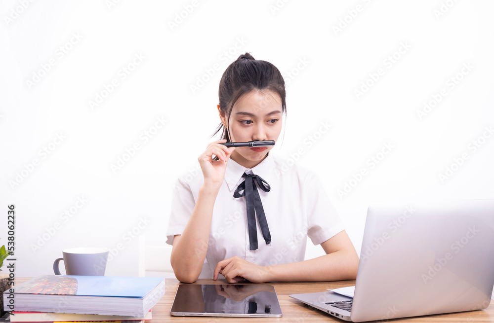 Asian female students taking an online class against a white background Asian female students taking an online class against a white background
