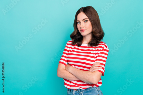 Portrait photo of young adorable pretty nice woman wear red striped t-shirt folded hands empty space shopping offer outfit isolated on cyan color background