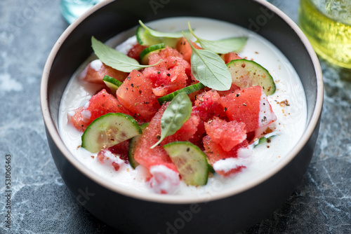 Closeup of cold summer soup made of watermelon, cucumber and buttermilk, selective focus, horizontal shot
