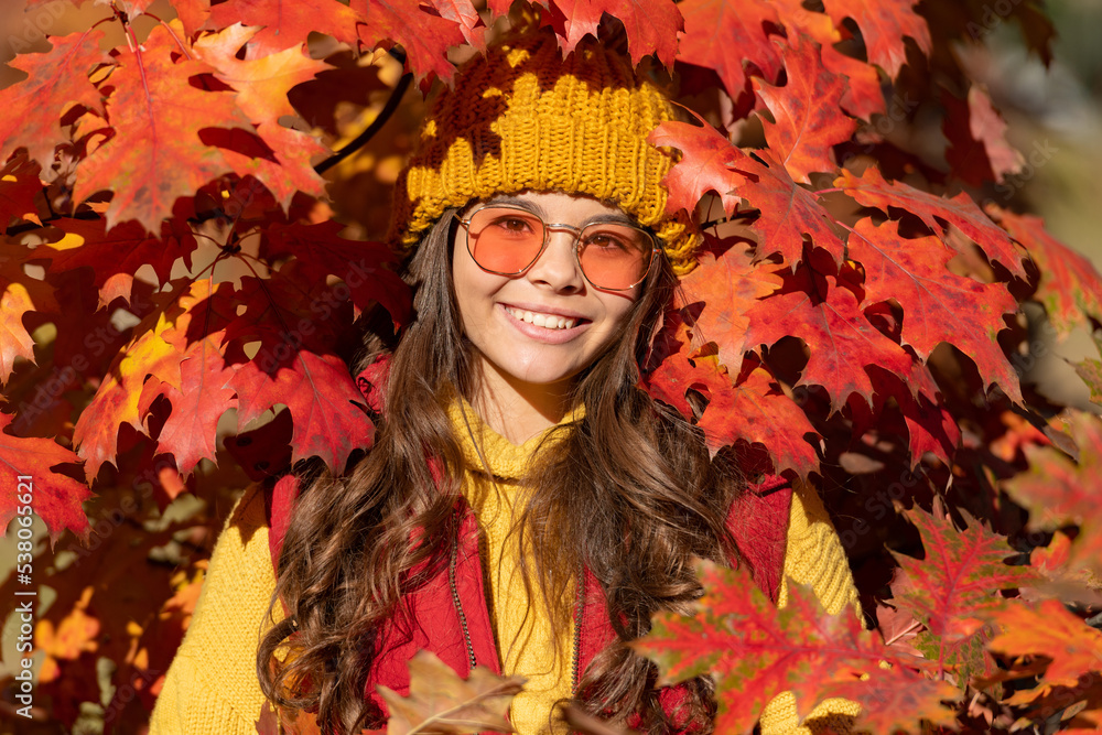 Child girl on autumn fall background, autumn kids face. smiling teen kid in sunglasses at autumn leaves on natural background Child girl on autumn fall background, autumn kids face. smiling teen kid in sunglasses at autumn leaves on natural background
