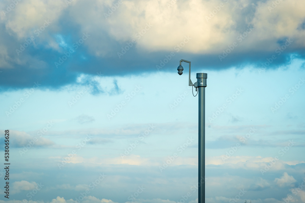 Sunny day view of UK motorway traffic with CCTV camera on foreground Sunny day view of UK motorway traffic with CCTV camera on foreground