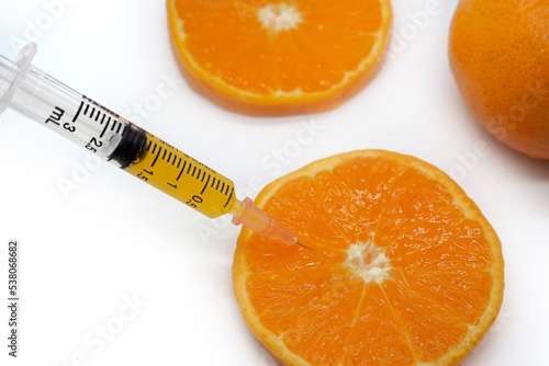 Syringe medicine put orange pieces texture background, concept mandarin, tangerine, wallpaper, vitamin c, natural, fruit, juice, vegetables, treatment, doctor, serum, laboratory