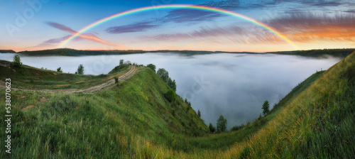 Beautiful landscape with a rainbow in the sky. spring landscape