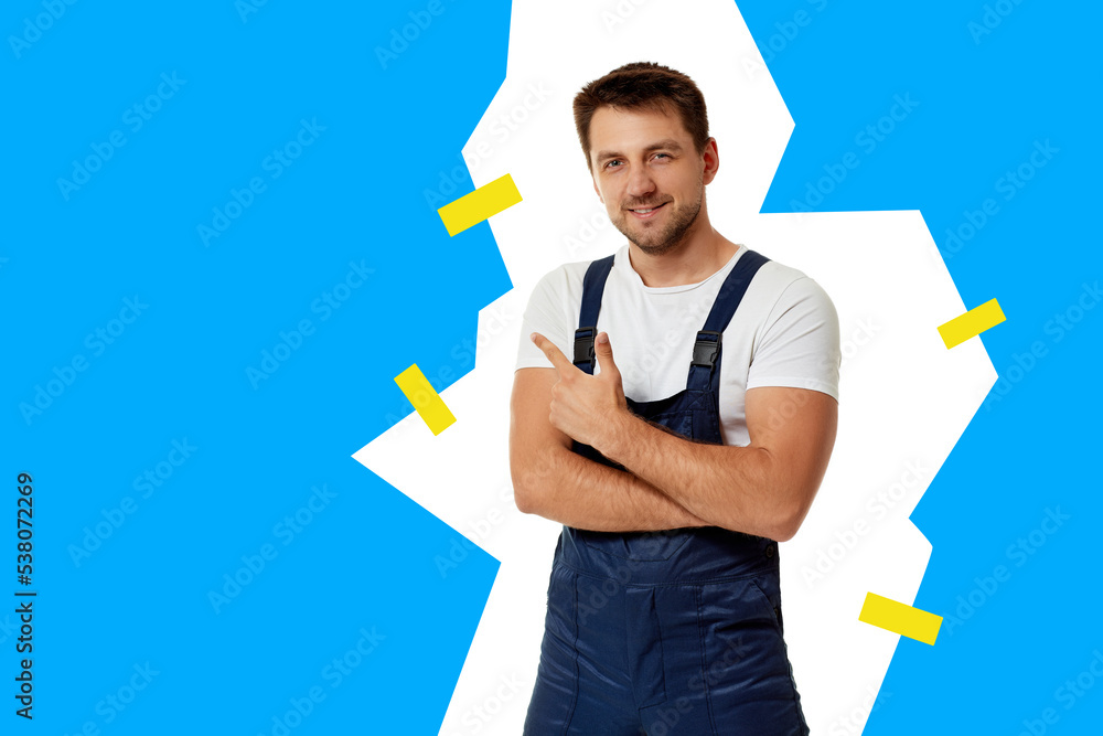 repairman in overalls pointing at copy space. repairman in overalls pointing at copy space.