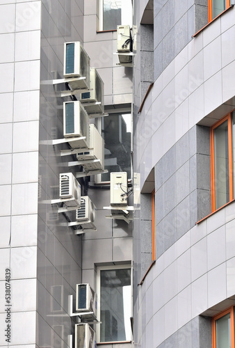 Air conditioning equipment on the wall of the building on an autumn day