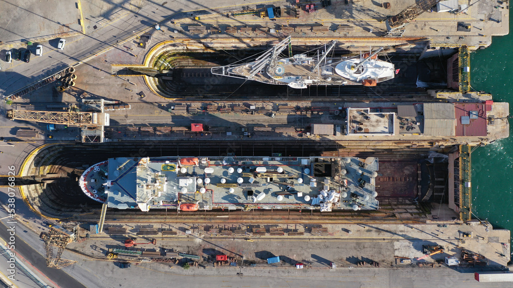 Aerial drone top photo of shipyard repairing small passenger vessels restoring sea and rust damage