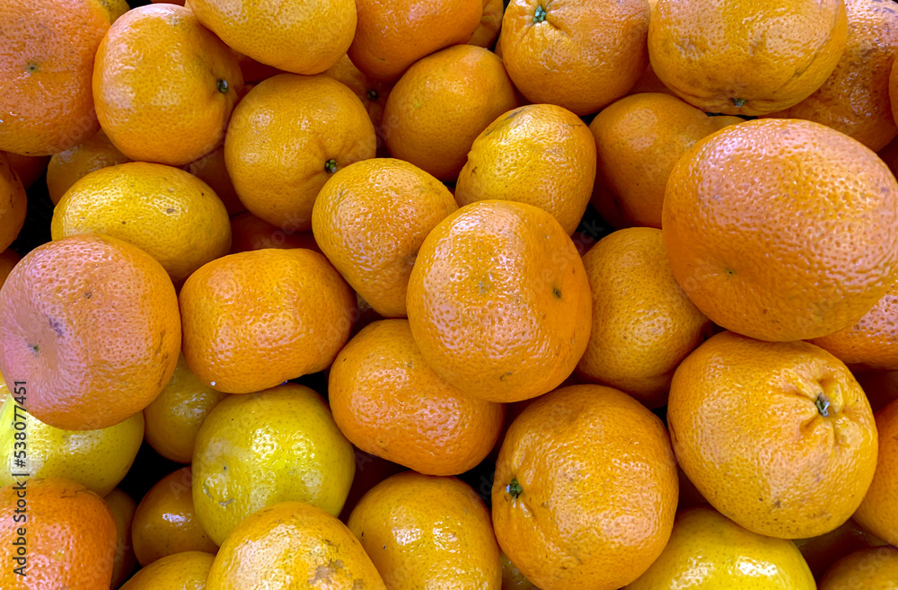 A pile of ripe oranges in the supermarket A pile of ripe oranges in the supermarket