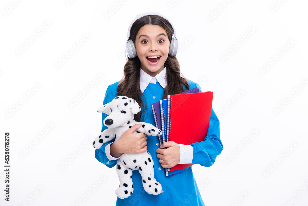Schoolchild, teenage student girl with toy on isolated studio background. School and education concept. Back to school. Excited face. Amazed expression, cheerful and glad. Schoolchild, teenage student girl with toy on isolated studio background. School and education concept. Back to school. Excited face. Amazed expression, cheerful and glad.